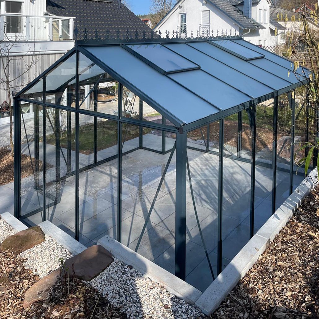 Freestanding T-shaped greenhouse with clear glass panels